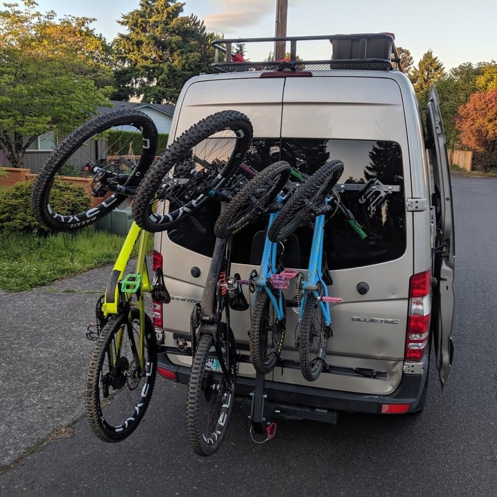Vertical hitch mounted bike rack for sprinter transit or van